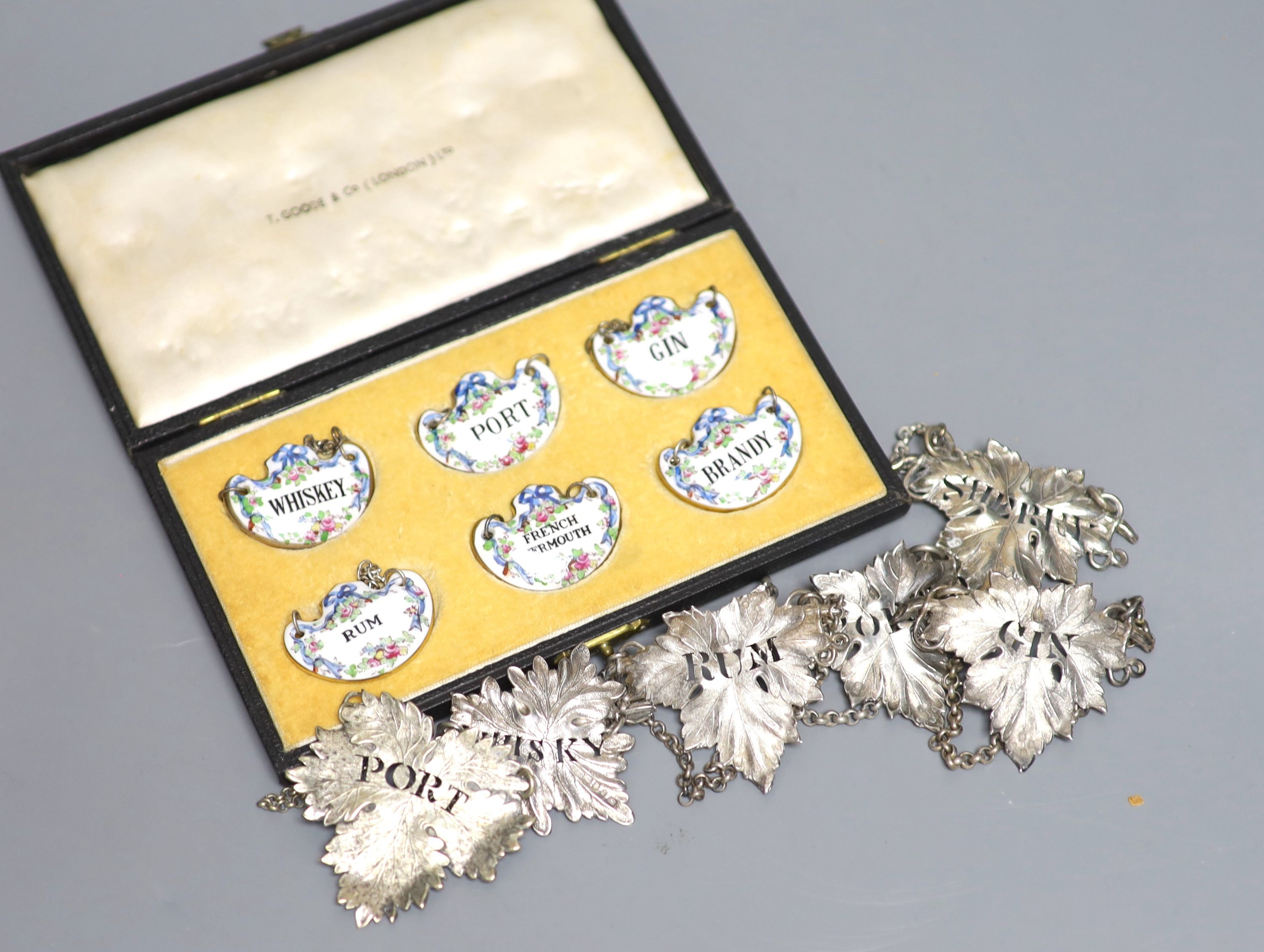 A set of four Victorian silver leaf shaped wine labels, London, 1874, 64mm, one other Victorian silver wine lable, a plated wine label and a set of six ceramic wine labels by Goode & Co.